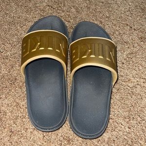 Size 7! Gold and black Nike slides
